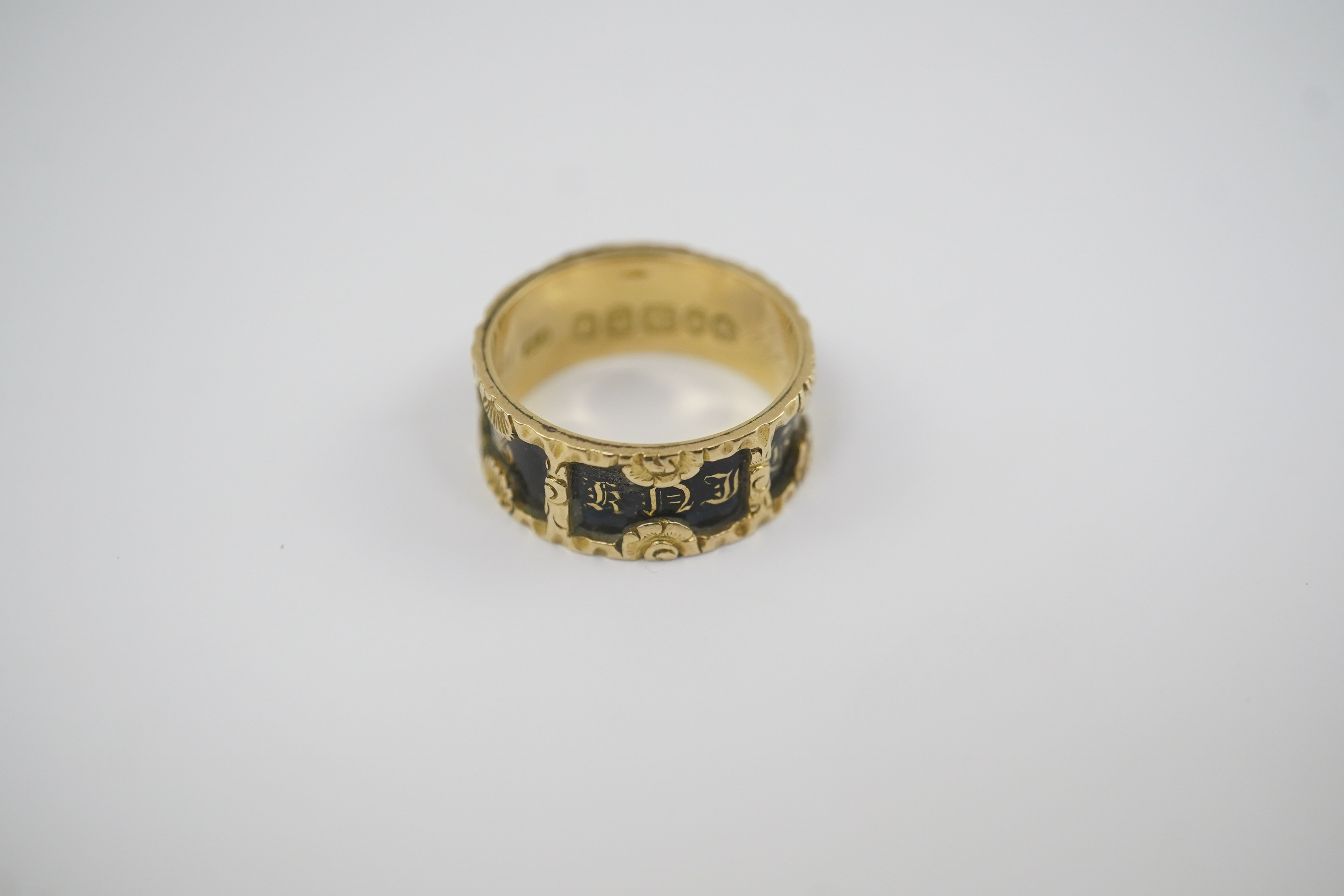 An early Victorian 18ct gold and black enamel initial mourning band